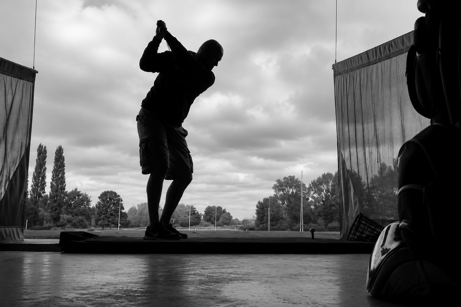 A golfer exploring a swing on the range